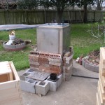 Here's the stainless steel tank surrounded by a double layer of bricks to help conserve the heat.  The cinder blocks are to stand on to reach down and get the woodenware out of the tank when the process is completed.